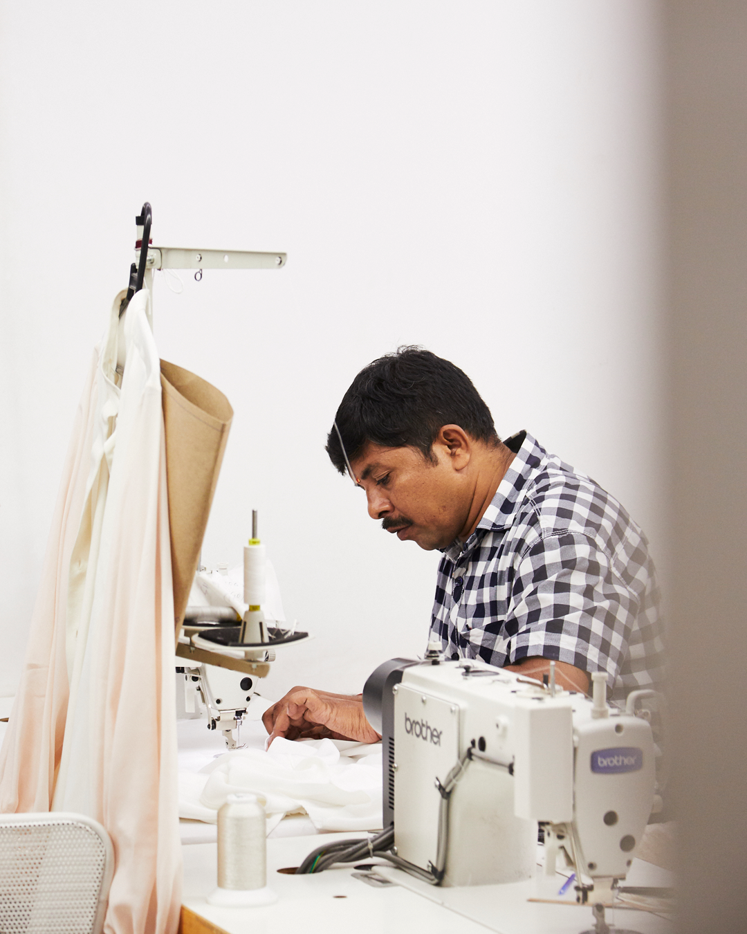 A skilled craftman hand-tailoring one of Varana's eco-friendly fashion garments