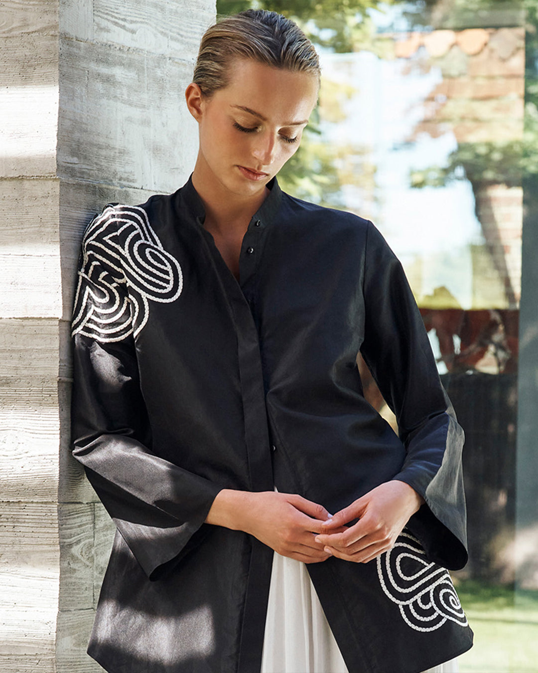 Woman wearing a black and white Rabari embroidered blouse