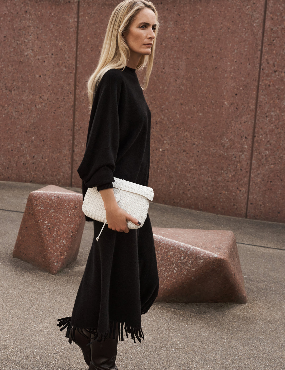 Woman walking down the street wearing a Black Fringed Cashmere Midi Skirt